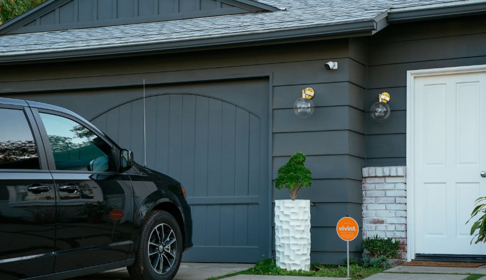 Garage door camera and vivent sign in the front yard.